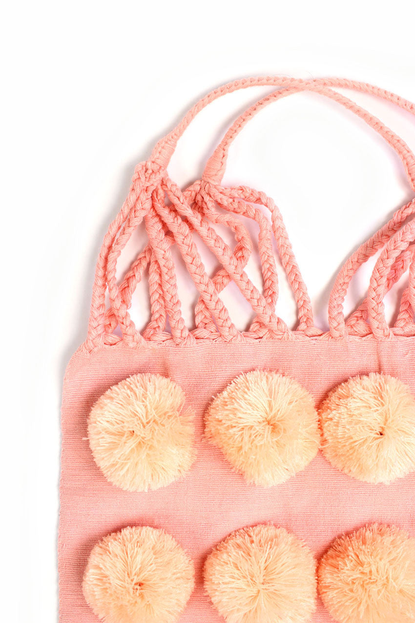 Bolsa de tela rosa con pompón