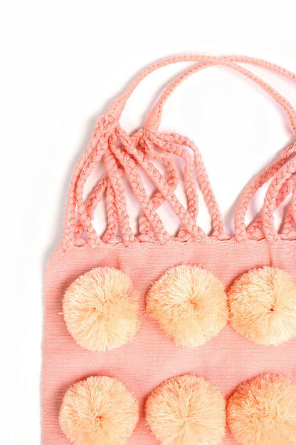 Bolsa de tela rosa con pompón